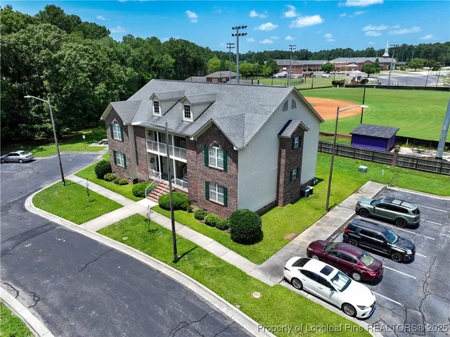 an aerial view of a house with swimming pool garden and patio