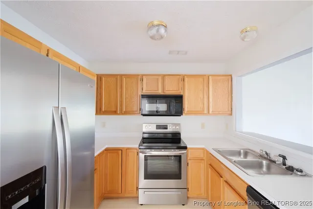a kitchen with a sink stove and refrigerator