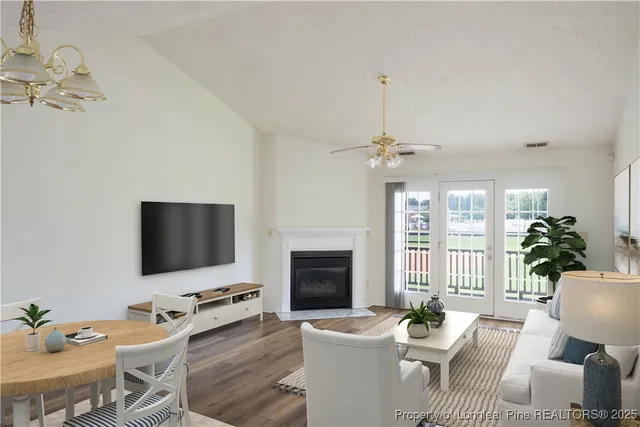 a living room with furniture a fireplace and a flat screen tv