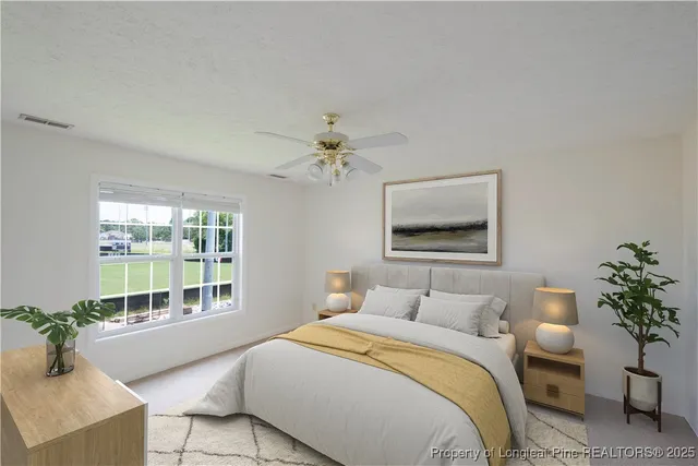 a bedroom with a large bed and a chandelier
