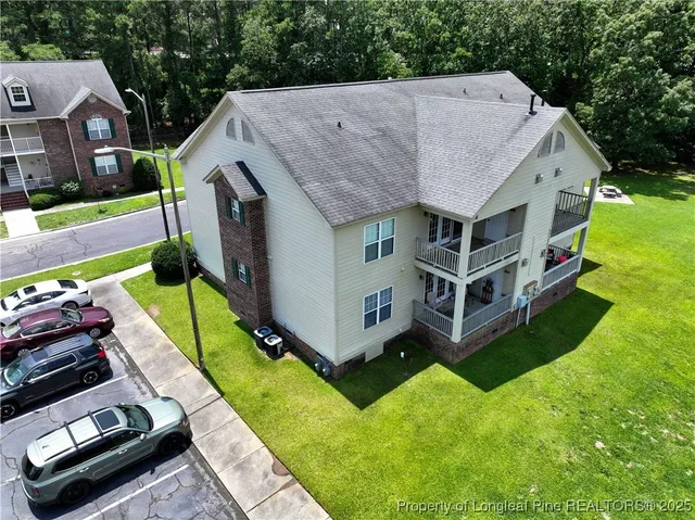 an aerial view of a house with a big yard
