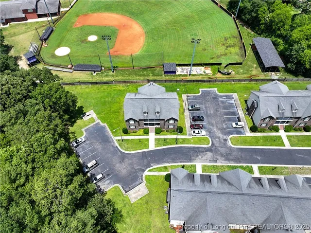 an aerial view of a house with a garden and lake view