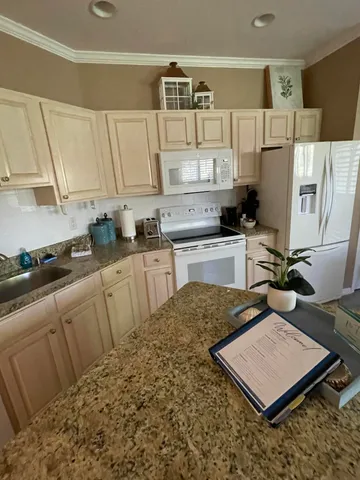 a kitchen with sink and cabinets