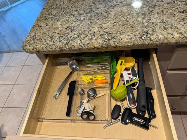 a bedroom with a bed a couch and a flat screen tv