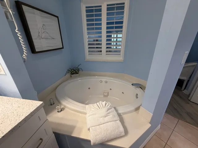 a bedroom with two beds and painting on the wall