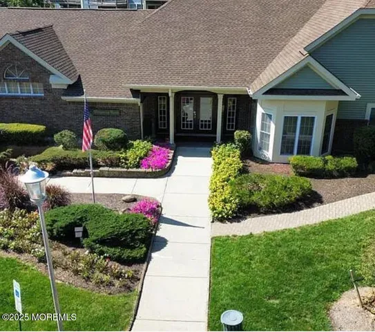 a front view of a house with a garden