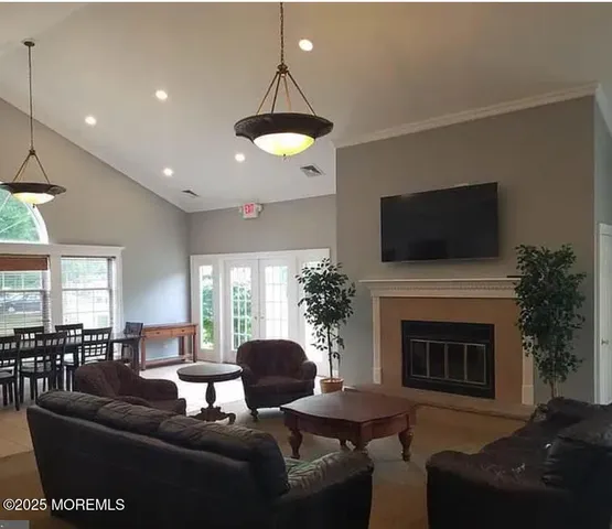 a living room with furniture a fireplace and a flat screen tv