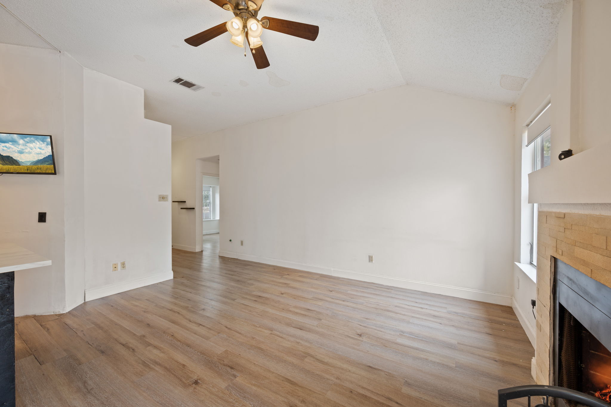 12501 Fallen Tower Lane Austin, TX 78753 - Photo 7 of 31 wooden floor in an empty room with a fireplace
