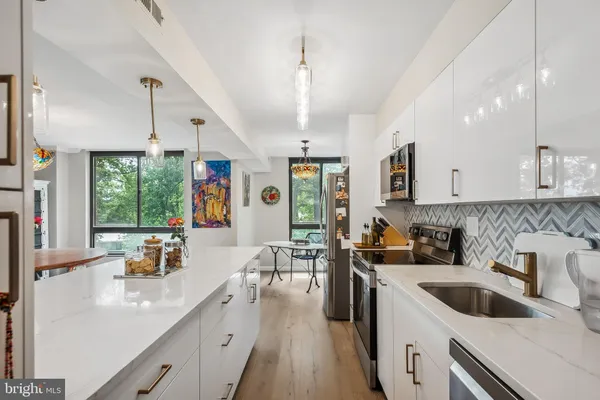 a kitchen with a sink stove and cabinets