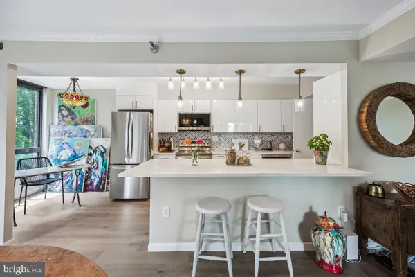 a kitchen with appliances cabinets and a dining table