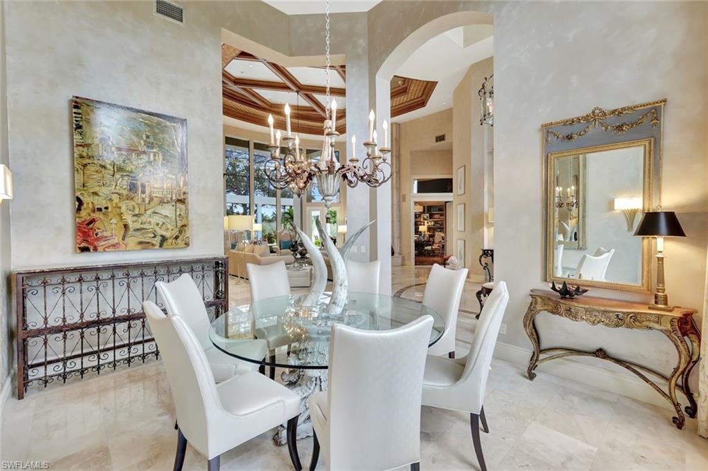 7261 Tilden Lane Naples, FL 34108 - Photo 15 of 46 a view of a dining room with furniture and chandelier
