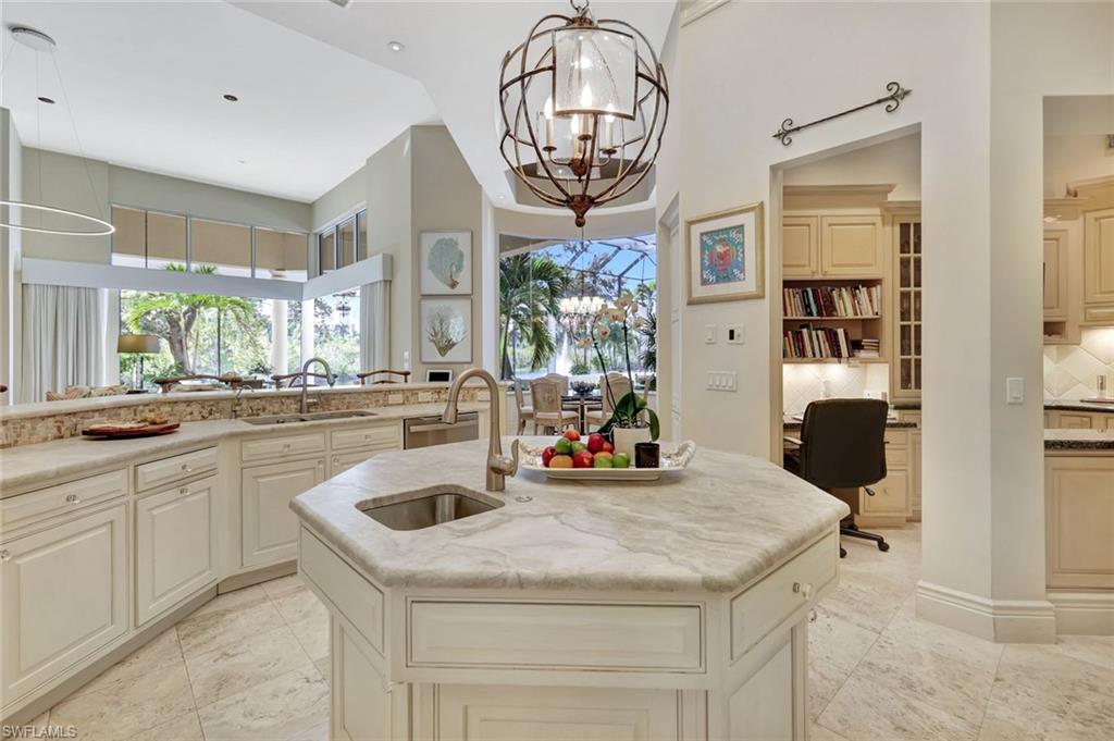 7261 Tilden Lane Naples, FL 34108 - Photo 18 of 46 a kitchen with a sink a counter top space and a chandelier