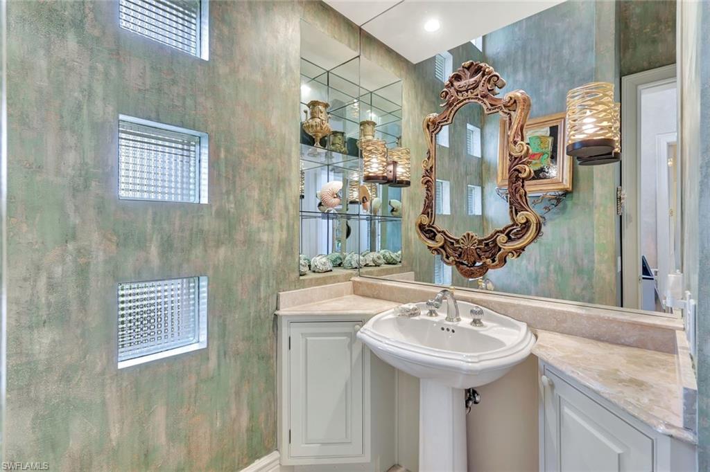 7261 Tilden Lane Naples, FL 34108 - Photo 26 of 46 a bathroom with a sink and a mirror