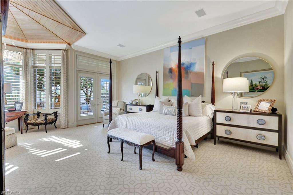 7261 Tilden Lane Naples, FL 34108 - Photo 28 of 46 a bedroom with bed and large windows