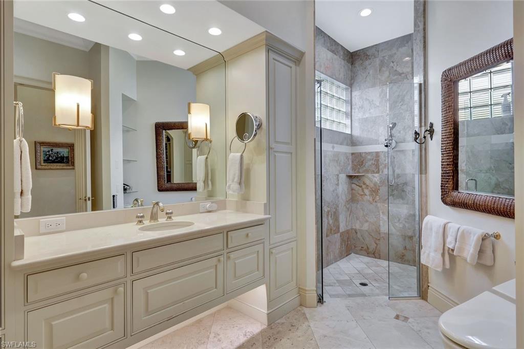 7261 Tilden Lane Naples, FL 34108 - Photo 32 of 46 a bathroom with a double vanity sink toilet and shower