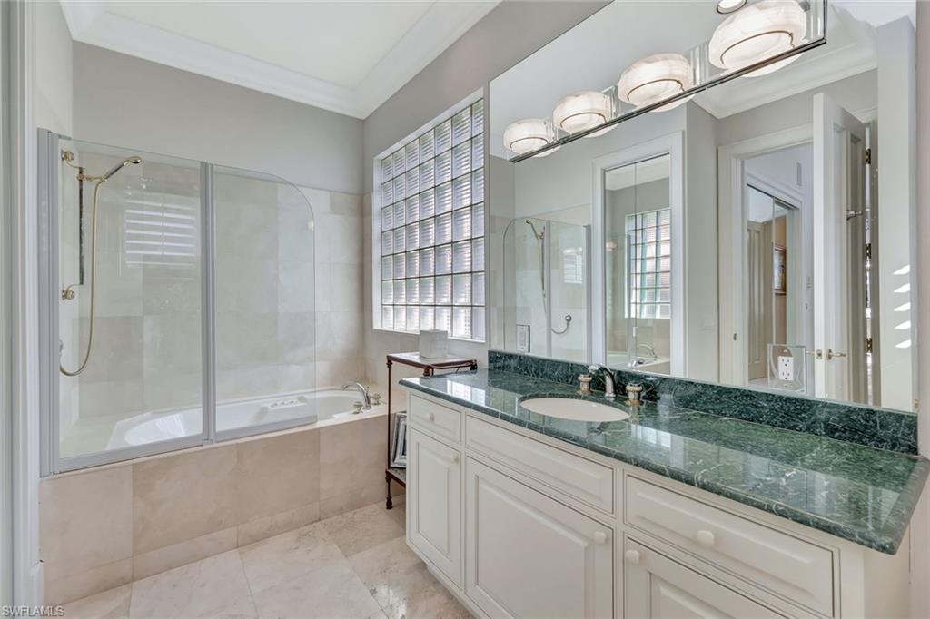 7261 Tilden Lane Naples, FL 34108 - Photo 34 of 46 a bath room with a sink and a mirror