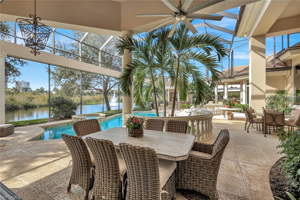 7261 Tilden Lane Naples, FL 34108 - Photo 4 of 46 a view of a patio with a table chairs and a floor to ceiling window