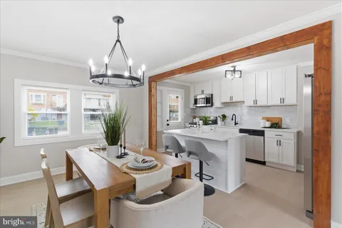 a view of kitchen with sink dining table and chairs