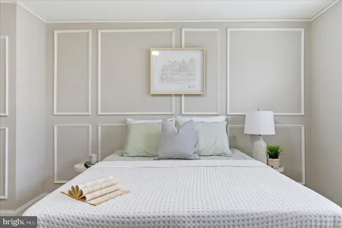 a bedroom with a bed and a lamp