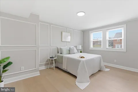 a spacious bedroom with a bed and a window