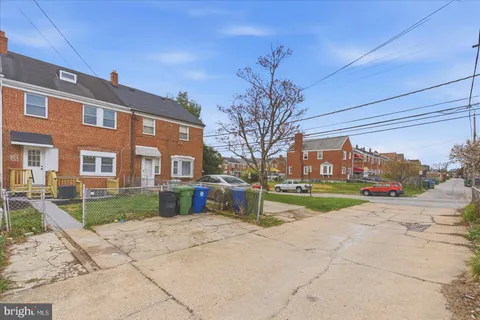 a view of a brick building next to a yard
