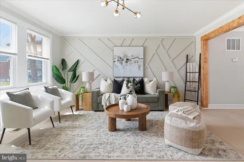 a living room with furniture and a potted plant