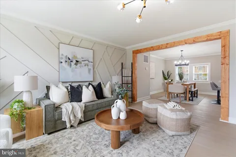 a living room with furniture and a dining table