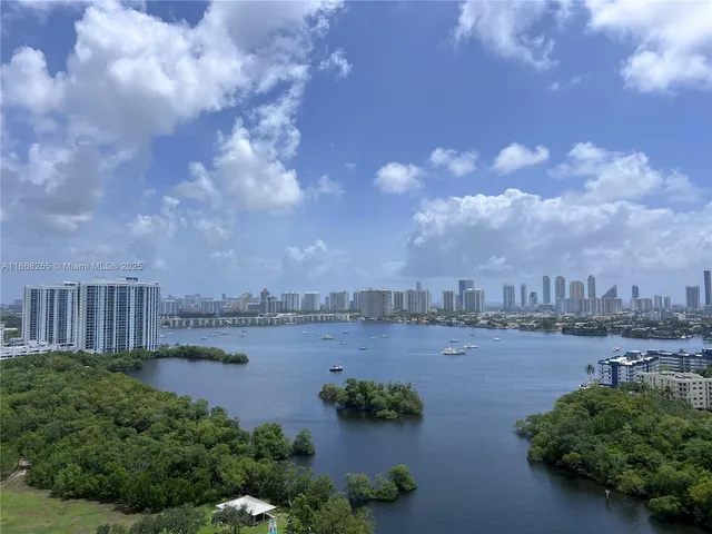 a view of a lake with houses in the back