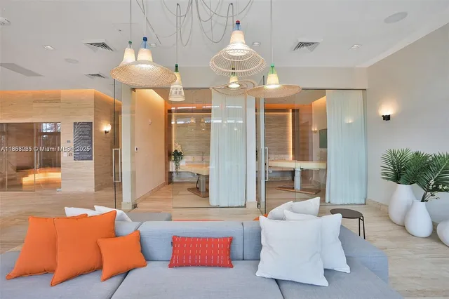 a living room with furniture and a chandelier
