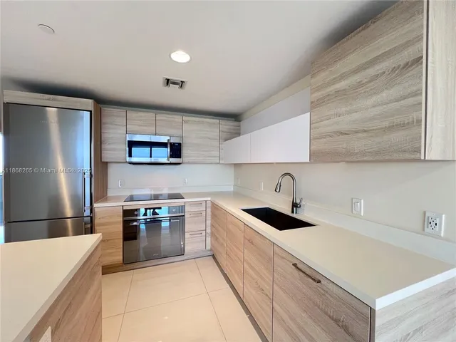 a kitchen with a sink a stove and refrigerator