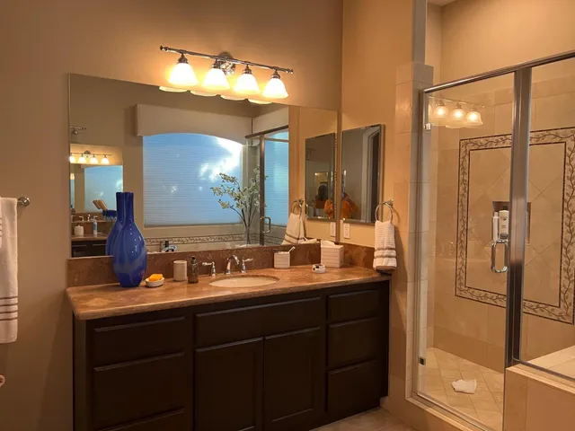 a bathroom with a double vanity sink and mirror