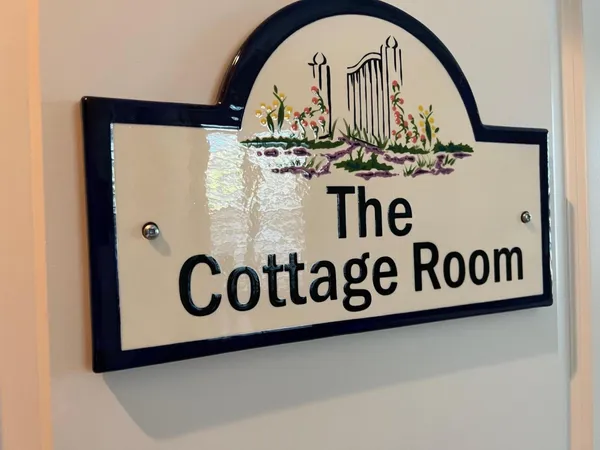 a bedroom with a bed and a flat tv screen on dresser