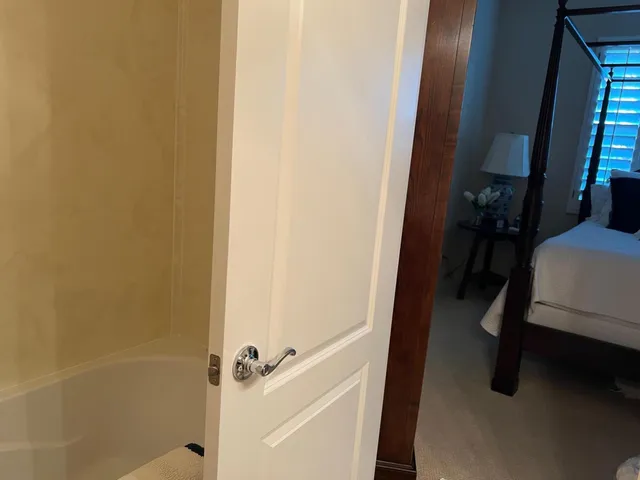 a bedroom with a large bed and a large window