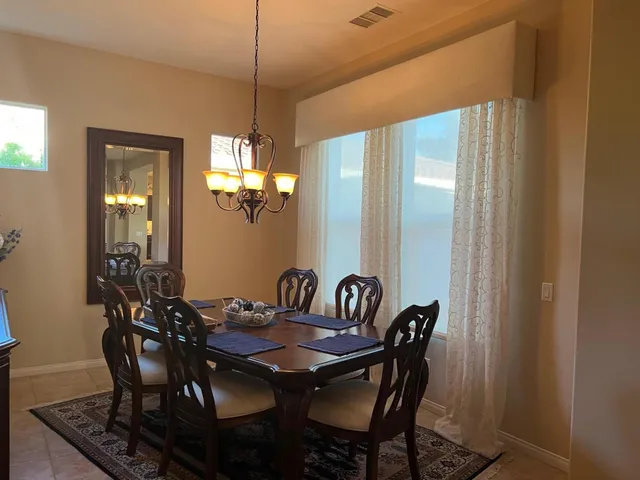 a view of a dining room with furniture and chandelier