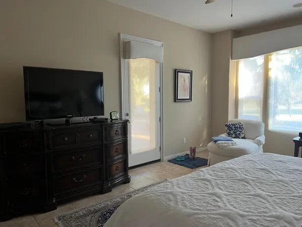 a bedroom with a bed and a flat screen tv