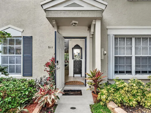 front view of a house with potted plants