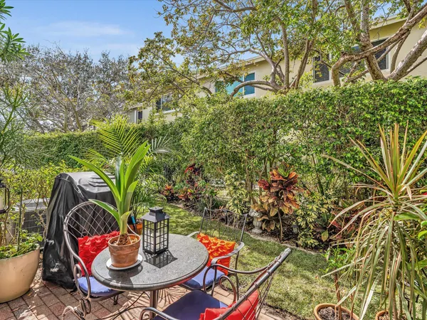 a backyard of a house with table and chairs
