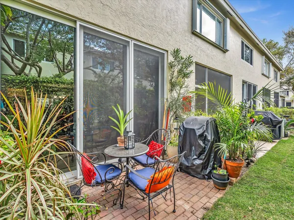 a view of a chairs and table in a backyard