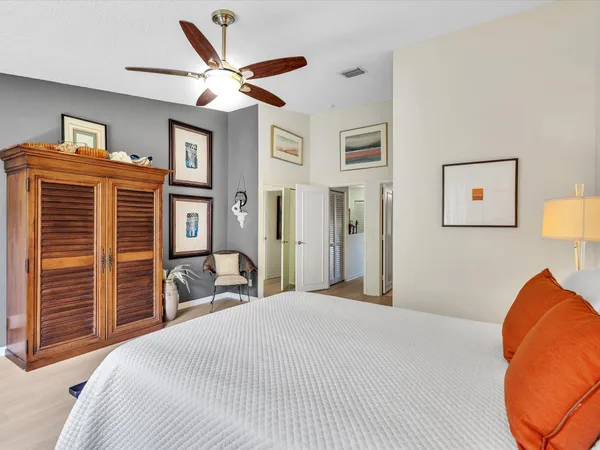 a bedroom with a bed and a chandelier