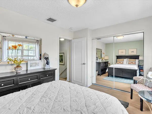 a bedroom with a bed and a view of living room