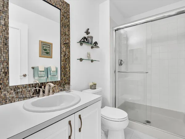 a bathroom with a sink toilet and shower