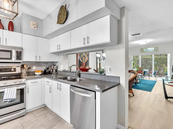 a kitchen with stainless steel appliances granite countertop a sink and cabinets
