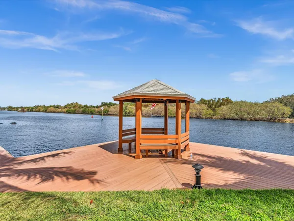 a blue bench sitting in front of a lake