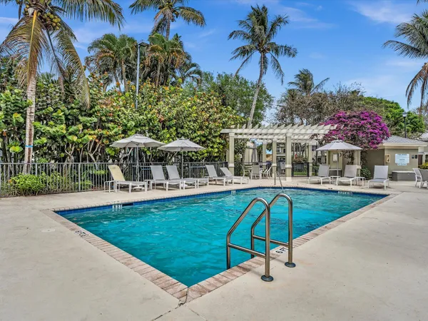 a view of a swimming pool with a patio and a garden