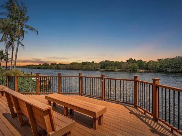 a view of a balcony with wooden floor and outdoor space