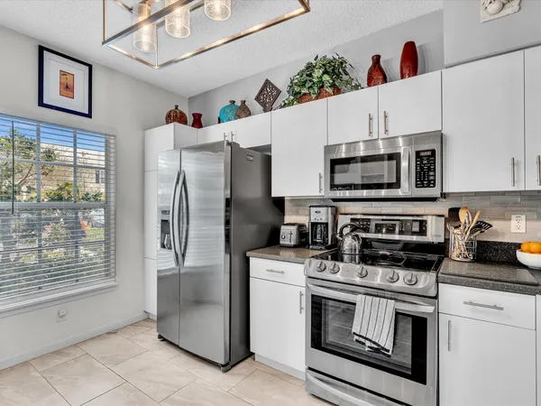 a kitchen with stainless steel appliances a stove microwave and refrigerator