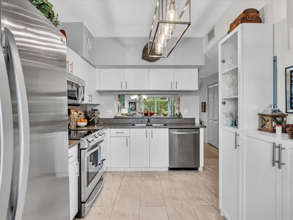a kitchen with cabinets and stainless steel appliances