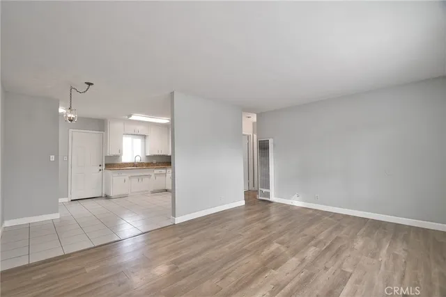 a view of a kitchen with wooden floor and a sink