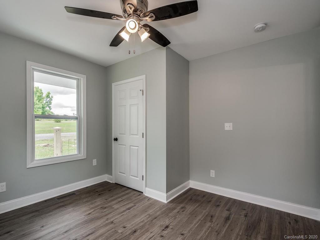 2096 Hardin Strait Road Chester, SC 29706 - Photo 14 of 27 a view of an empty room with wooden floor and a window
