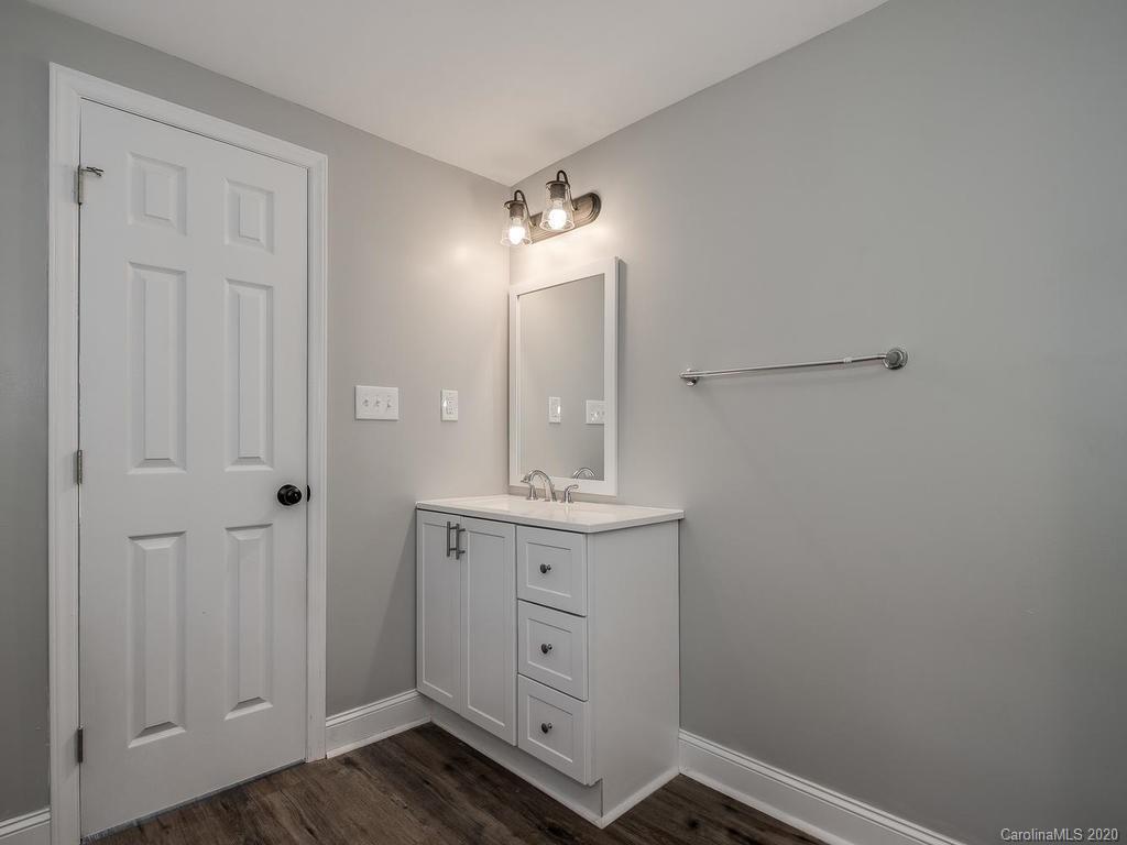 2096 Hardin Strait Road Chester, SC 29706 - Photo 20 of 27 a bathroom with a granite countertop sink a mirror and a vanity
